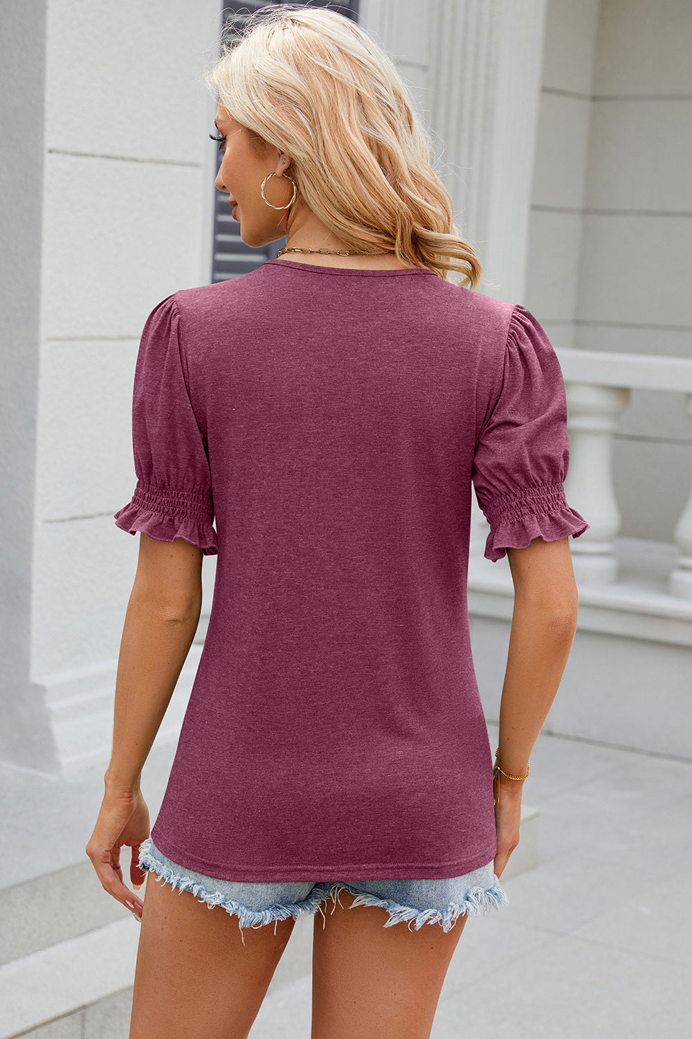 Puffed sleeve tee in Red-Violet with ruffled cuffs and a tie-neck detail.