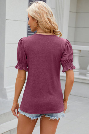 Puffed sleeve tee in Red-Violet with ruffled cuffs and a tie-neck detail.