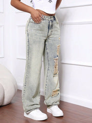 Distressed wide-leg acid wash jeans in light denim with ripped details.