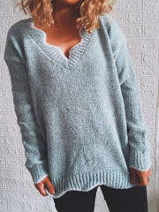 Light blue knit sweater with scalloped V-neck and ribbed trim.