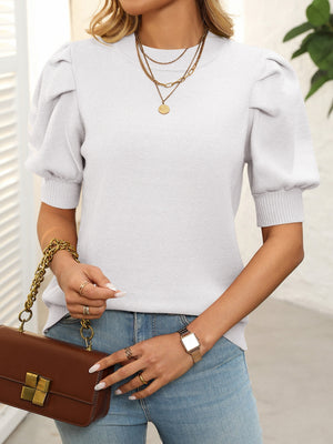 Light blue knit sweater with mock neck and puff sleeves.