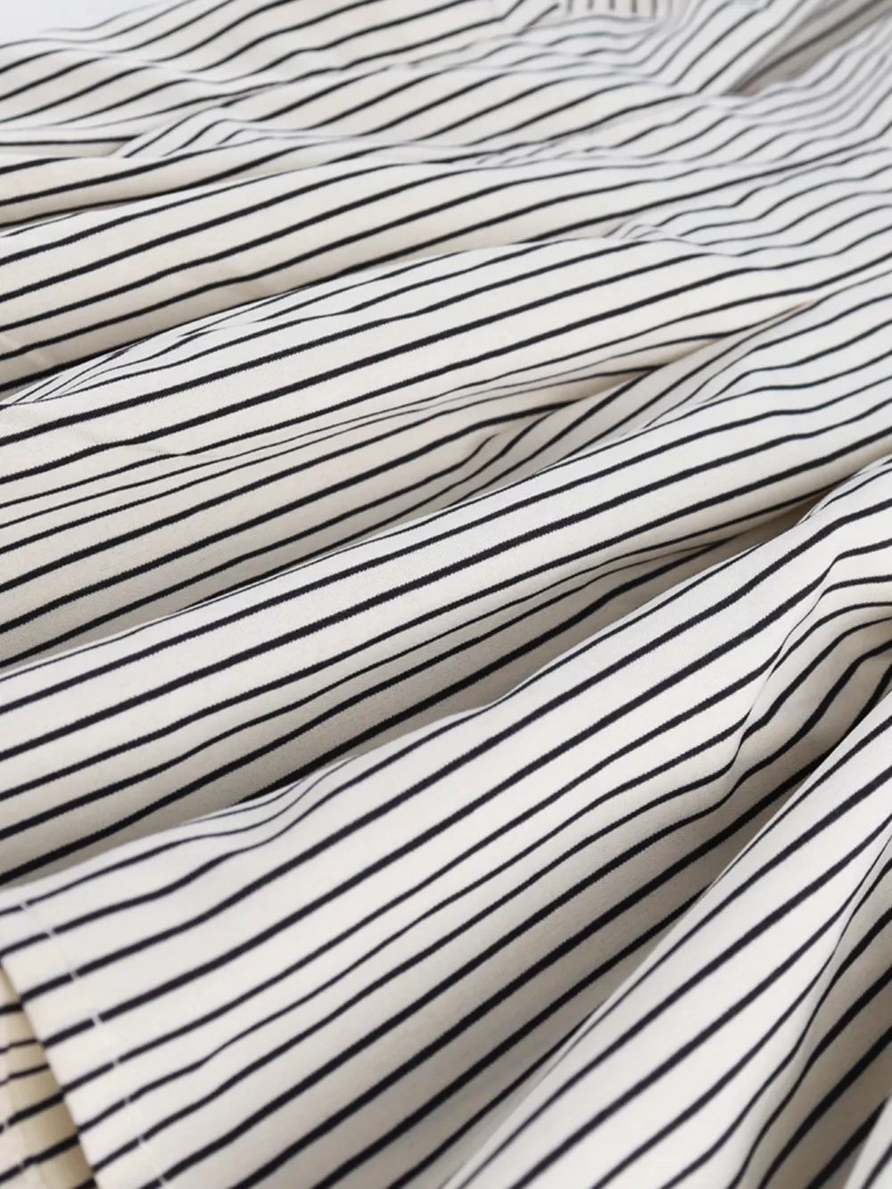 Maternity shirt with black and white stripes, cinched waist detail