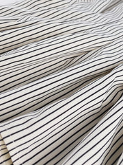 Maternity shirt with black and white stripes, cinched waist detail