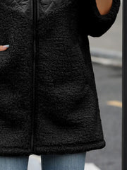 Black teddy hoodie with quilted panel detail and zip closure.