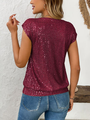 Crimson sequined cap-sleeve V-neck blouse with a cinched waist.
