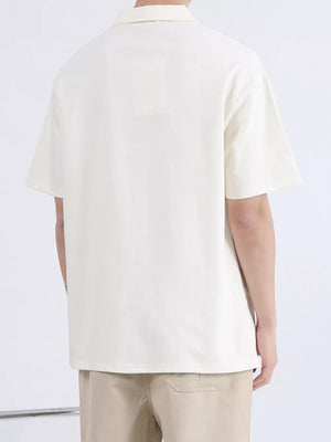 Men's apricot short-sleeve polo shirt with a relaxed fit and collar.
