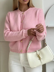 Textured knit cardigan in blush pink with gold button detail and crew neck.