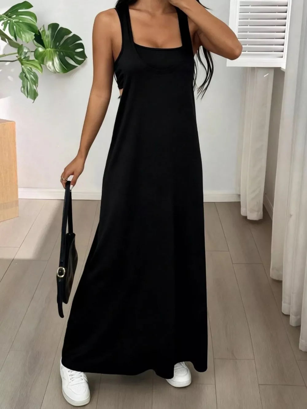 Black scoop neck cami maxi dress with a relaxed fit and tank straps.