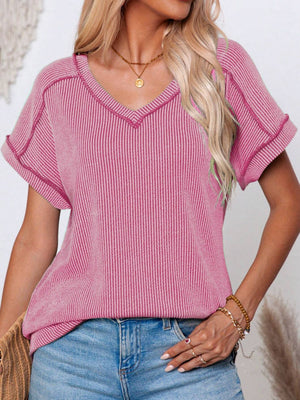 Pink ribbed V-neck t-shirt with contrast stitching and cuffed short sleeves.