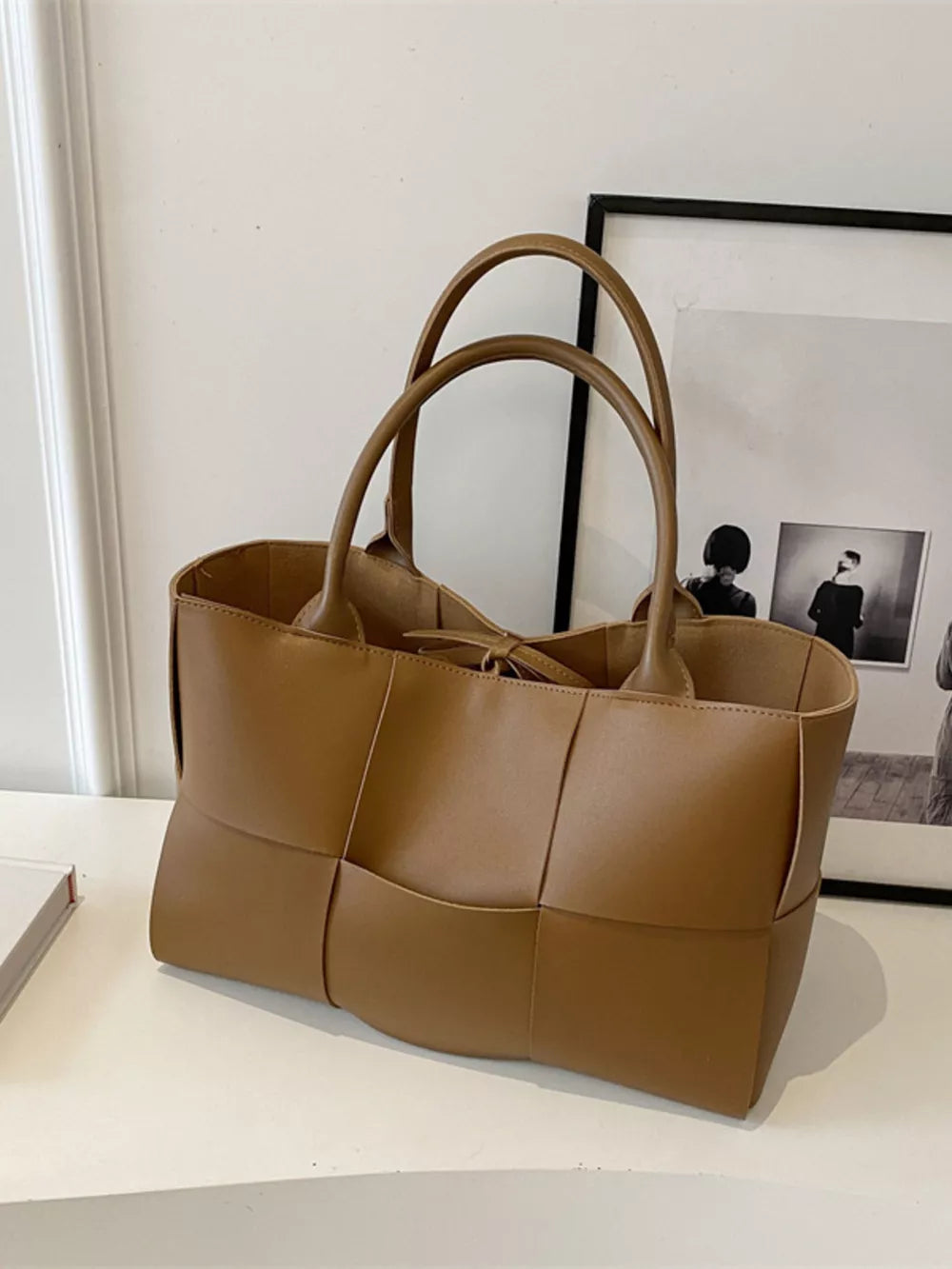 Brown woven PU leather large tote bag with double handles.