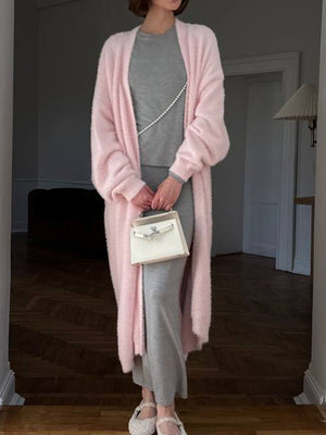 Plush pink maxi cardigan with balloon sleeves worn open over a gray dress.