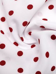 White polyester camisole with red polka dots and ruched tie detail.