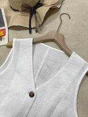 White textured vest with tortoiseshell button and V-neck