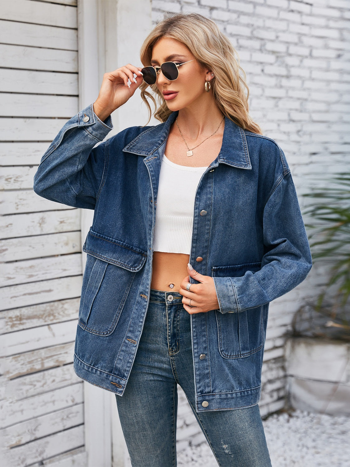 Chic denim button-up jacket in dusty blue with two chest pockets and a relaxed fit.