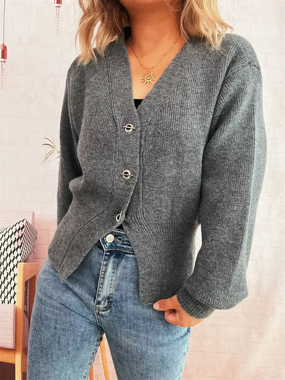Gray ribbed V-neck button-through cardigan with silver hardware details.