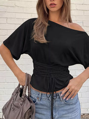 Black draped tie-front short sleeve t-shirt with dolman sleeves and asymmetrical neckline.