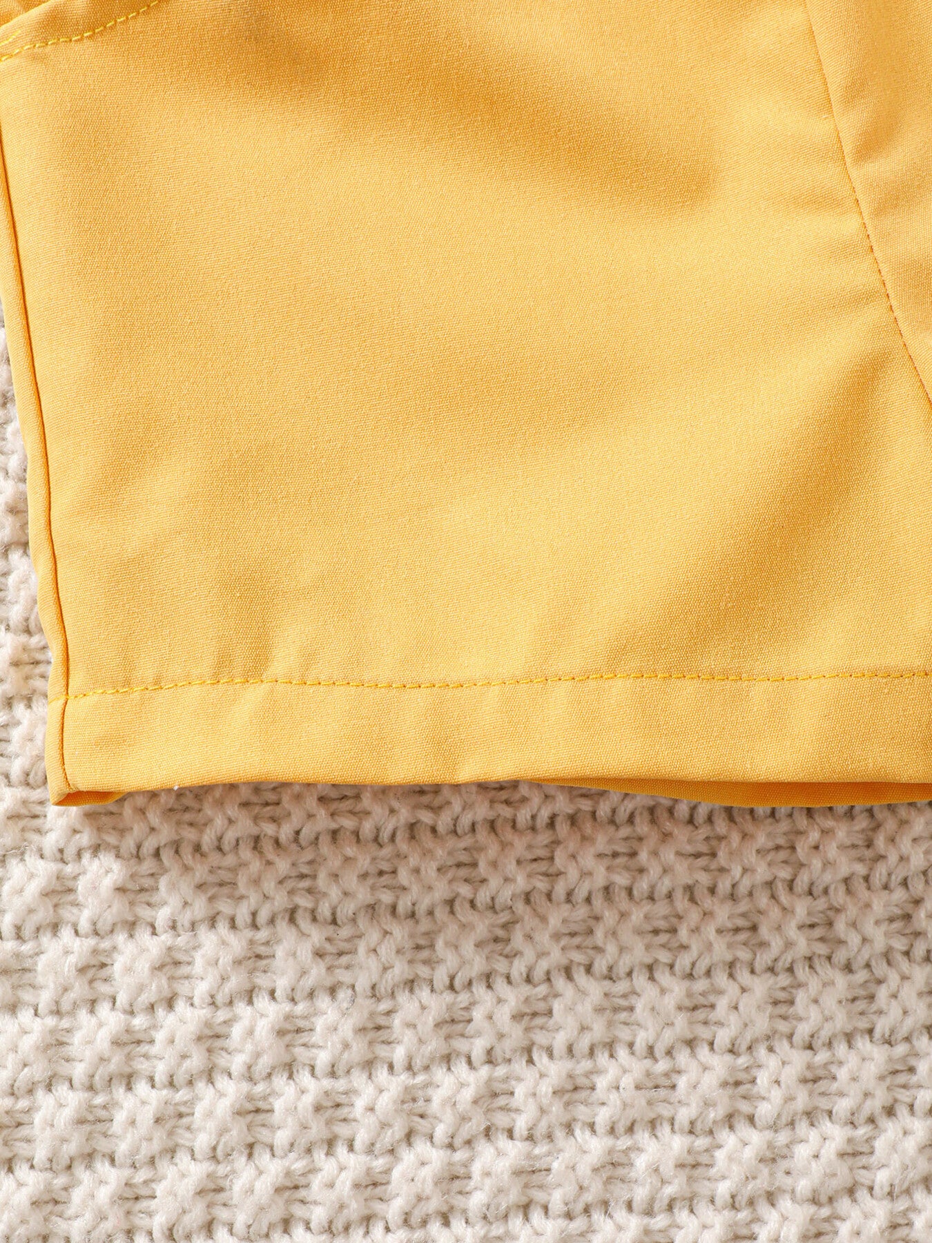 Yellow baby set detail with tropical print and bow tie accent