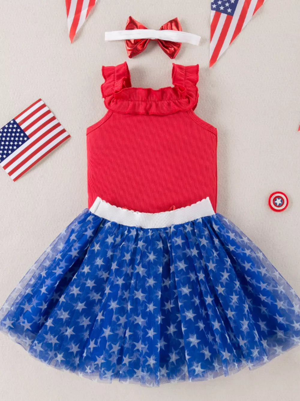 Red ruffled tank top and blue star print tulle skirt set with bow headband.