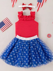 Red ruffled tank top and blue star print tulle skirt set with bow headband.