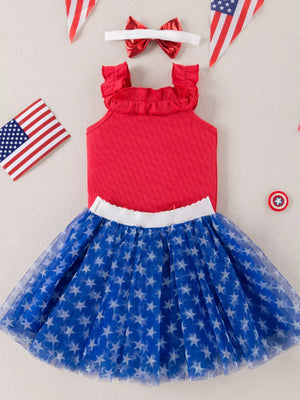Red ruffled tank top and blue star print tulle skirt set with bow headband.