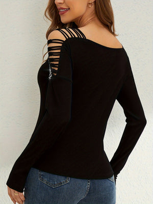Black ribbed knit blouse with strappy cold shoulder and embellished detail.