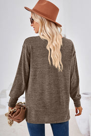 Relaxed V-neck tunic top in heathered taupe with long sleeves and a casual fit.