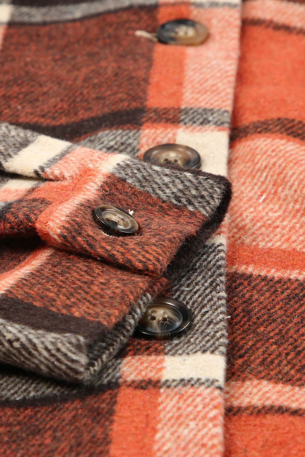 Plaid hooded shacket in orange with button details and a relaxed fit.