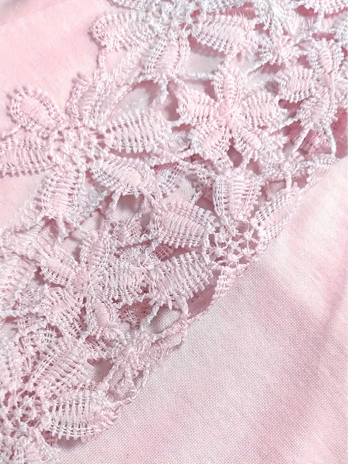 Blush pink blouse with delicate lace yoke and sleeve detail.