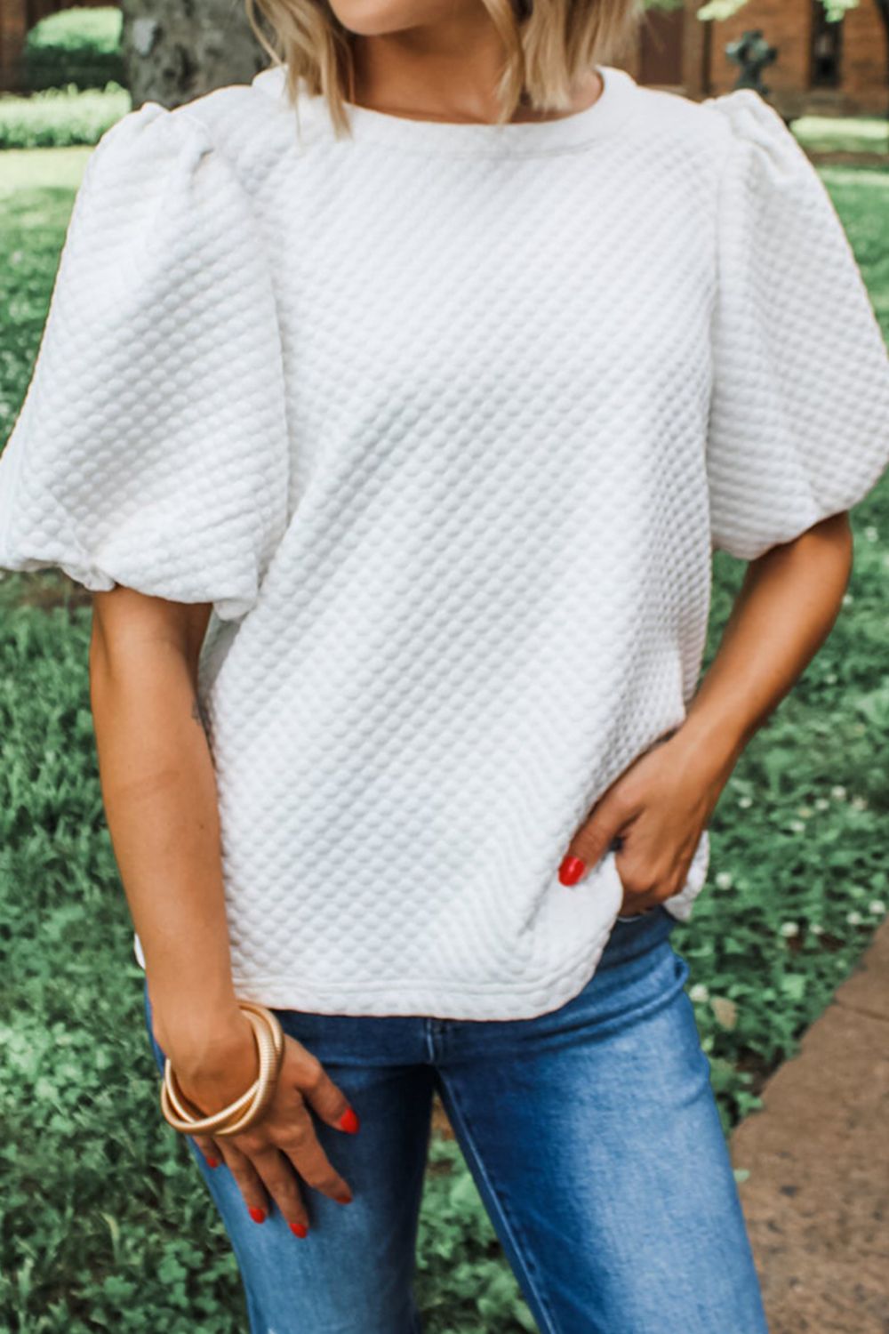White textured quilted blouse with puff sleeves and crew neck.