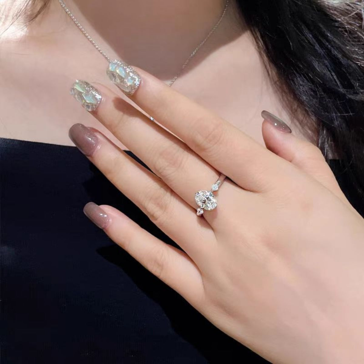 Sterling silver ring with oval moissanite and accent stones