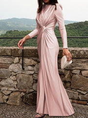 Pink ruched knot front maxi dress with long sleeves and a draped skirt.