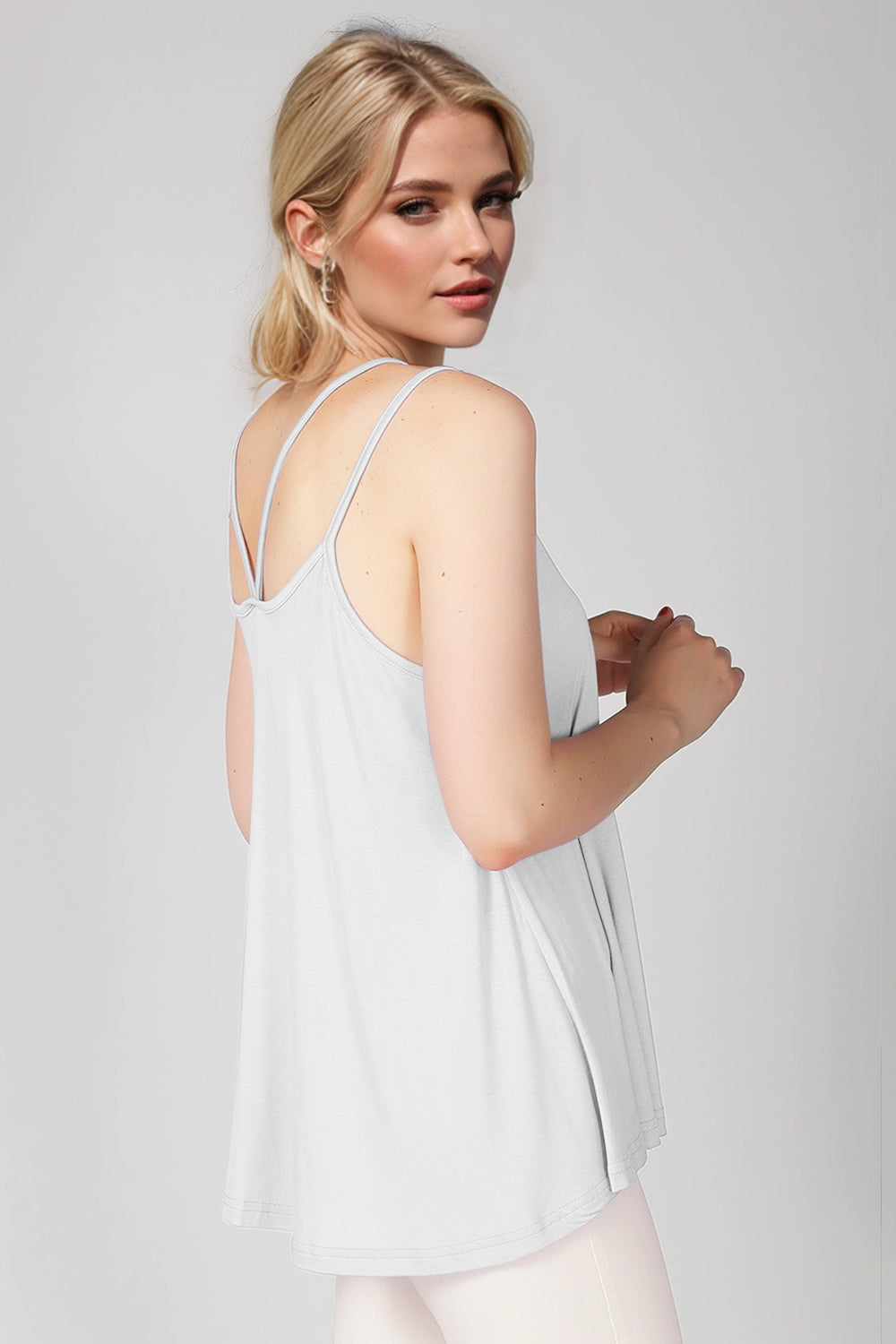 White trapeze cami with double straps and a relaxed fit.