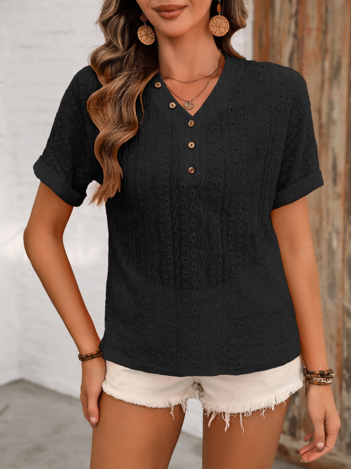 Black eyelet henley blouse with short sleeves and button detail