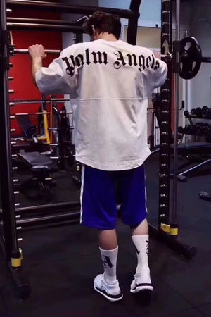 White Palm Angels oversized tee with black back print, crew neck, and short sleeves.