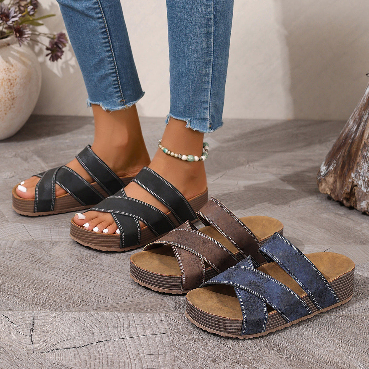 Criss-cross open-toe platform sandals in black, brown, and blue with chunky soles.