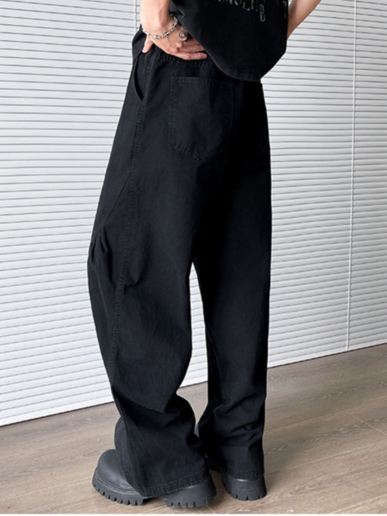 Men's black pocketed wide leg sweatpants with elastic waist and belt loops.