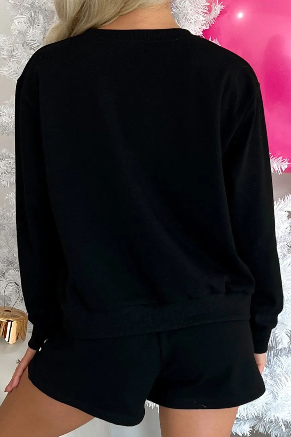 Black loungewear set with long sleeve top and shorts.