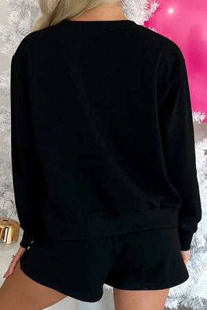 Black loungewear set with long sleeve top and shorts.