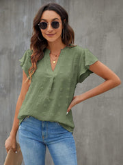 Flutter sleeve Swiss dot blouse in Matcha Green with a V-neckline.