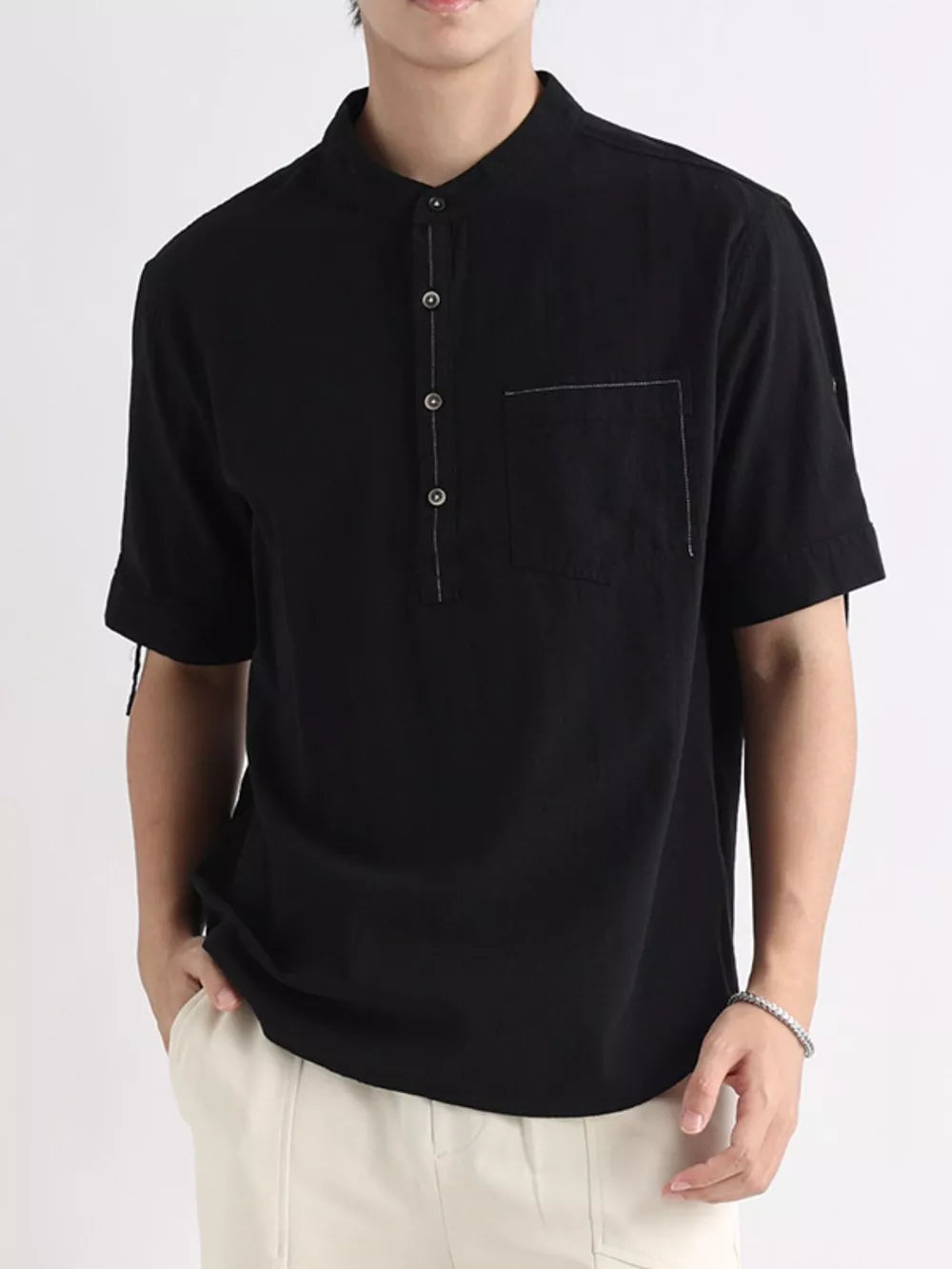 Black cotton button-down shirt with mandarin collar and chest pocket.