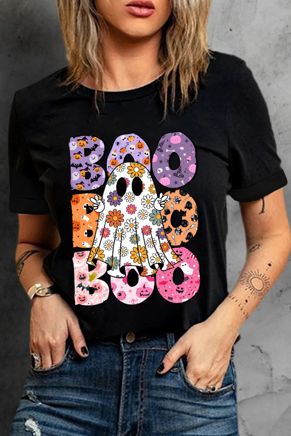 Black t-shirt with a floral ghost graphic and "Boo" text in Halloween patterns.