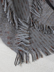 Textured fringe shawl cardigan in dark gray acrylic with subtle copper threads and fuzzy trim.