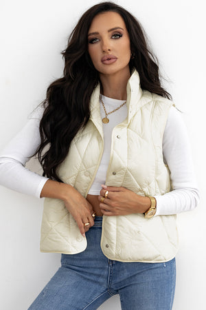 Ivory quilted stand collar vest with snap closure, styled with a white long sleeve top.