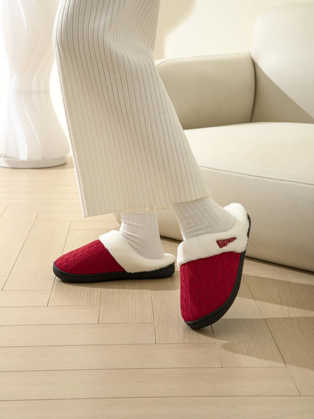 Deep Red cable knit shearling house slippers with white trim.