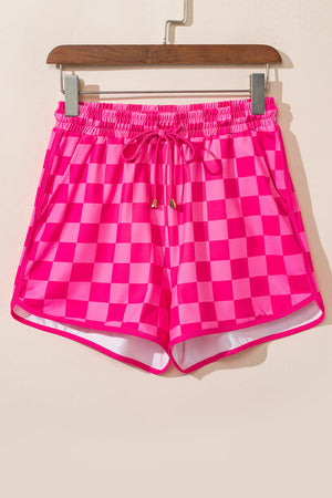 Hot pink checkerboard lounge shorts with drawstring and contrast trim