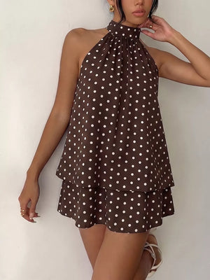 Coffee brown polka dot halter mini dress with tiered skirt and high neckline.