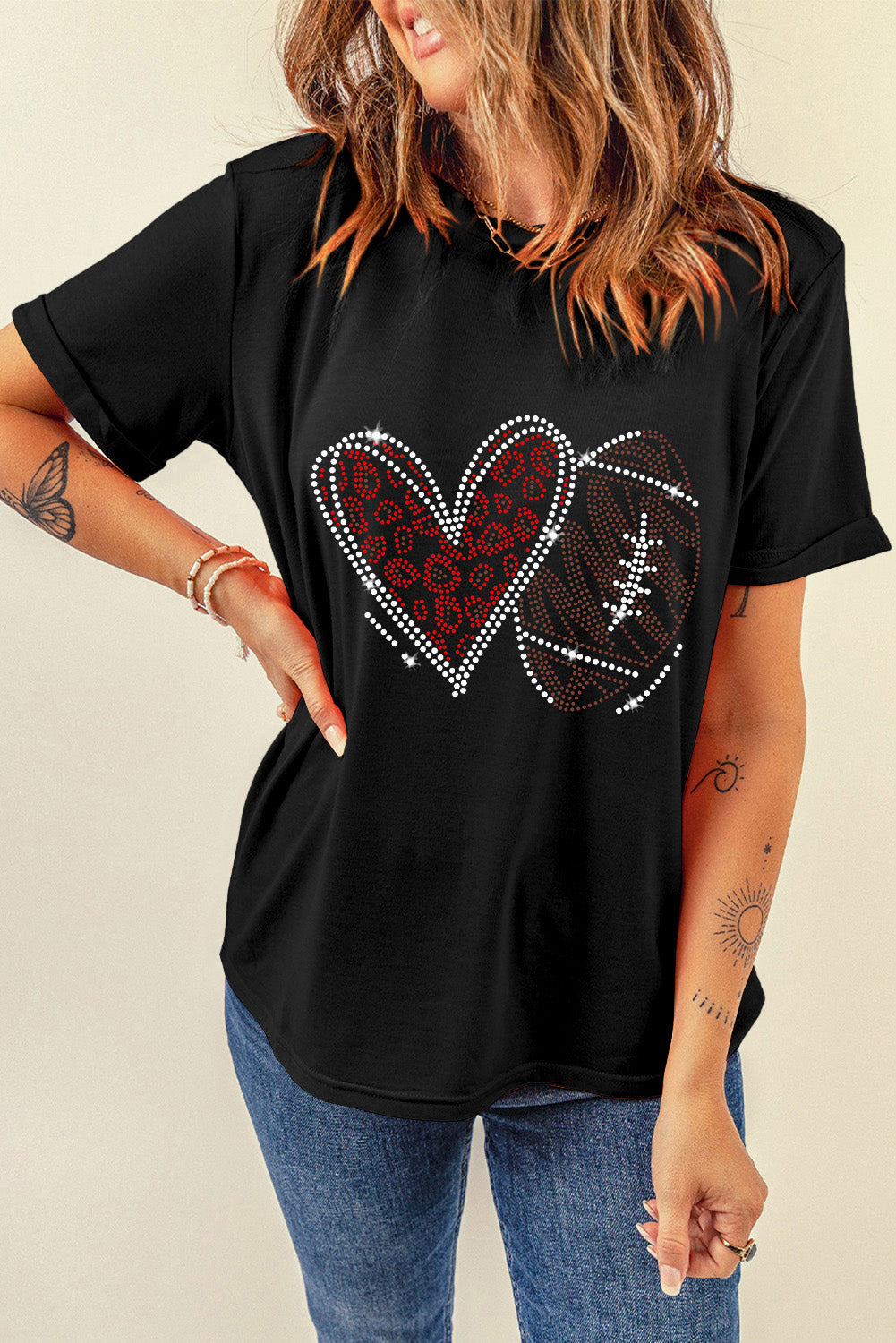 Black t-shirt with rhinestone heart and football graphic.