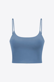 Light blue scoop neck crop tank top with thin spaghetti straps.