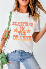 White t-shirt with faded retro graphic print and orange stars.