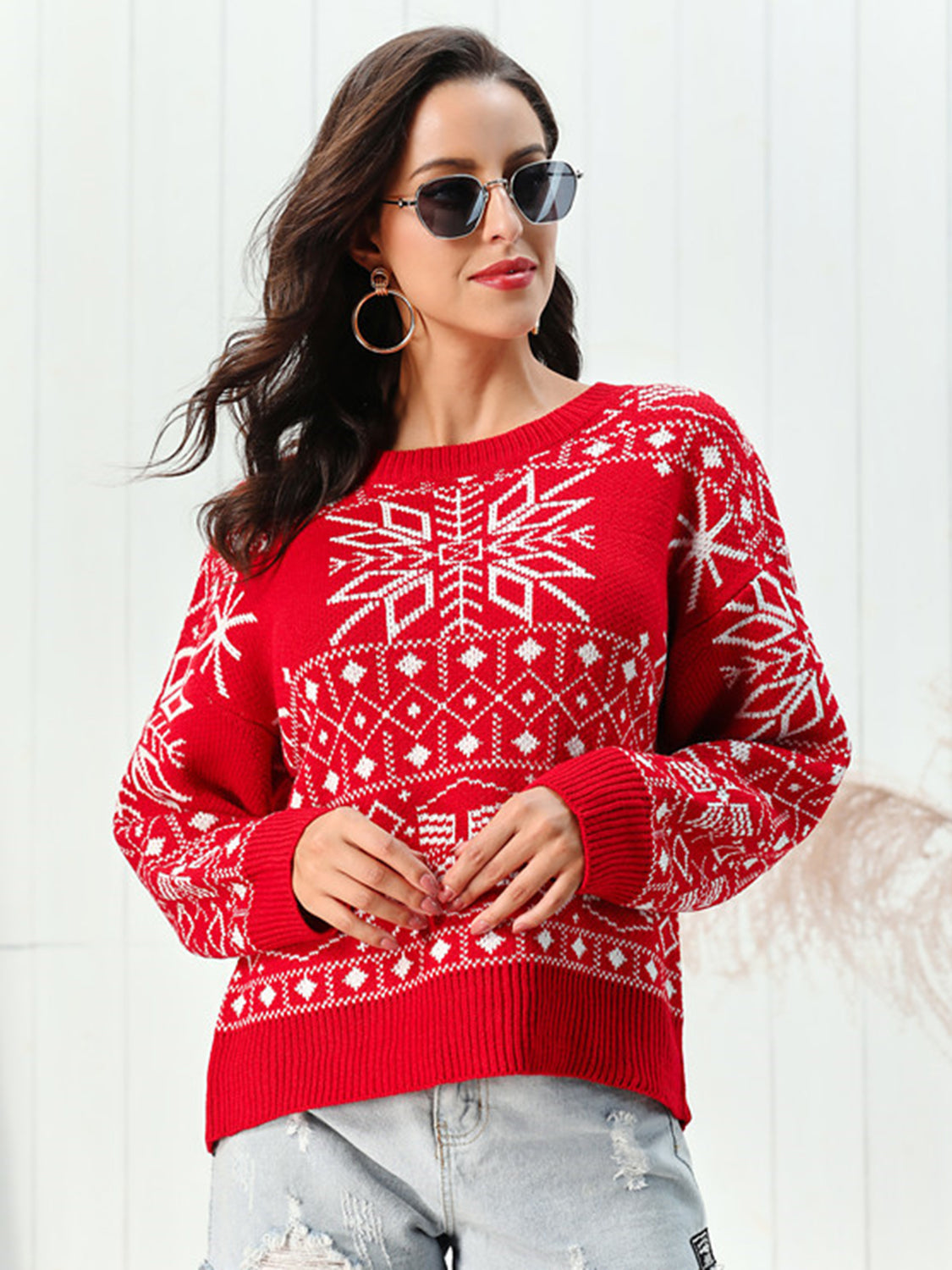 Red acrylic crewneck sweater with white snowflake pattern.